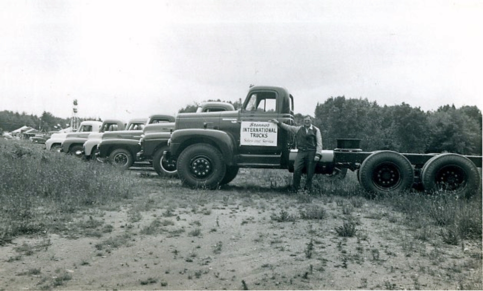 Harold Brenno and his International trucks. Brenno family photo.
